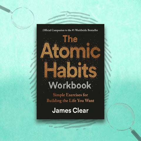 Book cover of 'The Atomic Habits Workbook' by James Clear on a light blue background